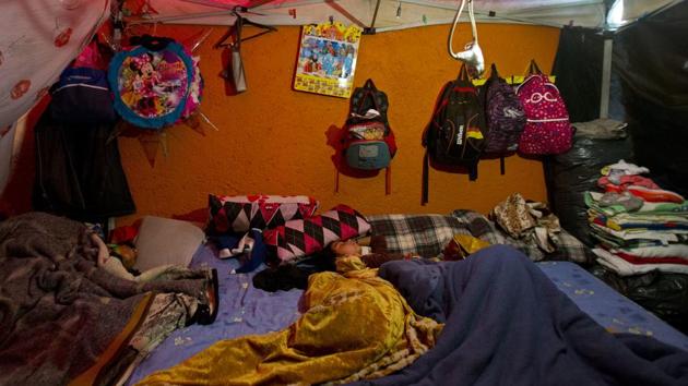 Children sleep in a shelter built against the external wall of a house, in a tent camp outside a damaged building in Mexico City. Despite living on the street, daily life continues, with children attending school and adults heading to work daily. Residents say security in the neighbourhoods is a problem, and one reported occasionally hearing gunshots in the night. (Rebecca Blackwell / AP)
