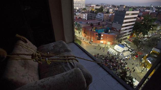 Movers prepare to lower a couch through the missing windows of an apartment inside the condemned “Great Bear” building in Mexico City. Several of the 15-story apartment towers which survived the 1985 earthquake and were known locally as the “Soldominios,” a nickname combining the Spanish words for soldier and condominium were damaged in September. Workers rubbled many simply with pickaxes. (Rebecca Blackwell / AP)