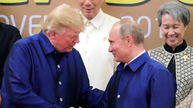 US president Donald Trump and Russian President Vladimir Putin shake hands during a photo session at the APEC summit in Danang, Vietnam on November 10, 2017.(Reuters File Photo)