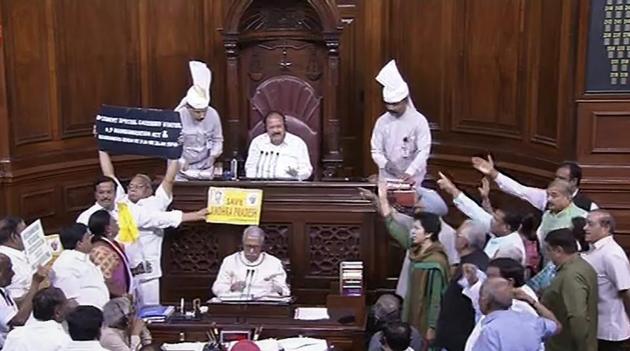Opposition members protest during the ongoing budget session of the Rajya Sabha, at Parliament House in New Delhi on March 21.(PTI Photo)