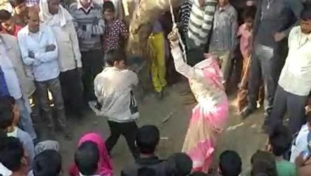 The video shows a woman tied to a tree while a man, allegedly her husband, beats her. Hindustan Times could not independently verify the authenticity of the video clip.(Videograb)