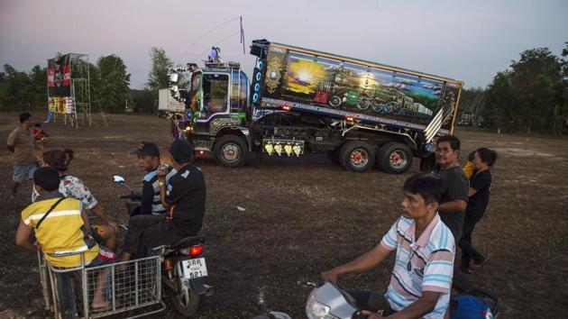 Though decorating vehicles is prohibited by Thai law over safety concerns, drivers get away with small fines and sympathy from admiring police officers. That wasn’t always the case. The community was long perceived as led by shadowy, drug-ridden machos idolising “bad boy” icons from Che Guevara to Saddam Hussein with stickers on their trucks. (Lillian Suwanrumpha / AFP)