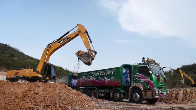 That is certainly the case for Wichukorn Wongdara who drives a bright green truck carrying rocks from an out-of-town quarry destined for a Bangkok construction site. The unicorn on his truck - designed by his daughter - aims to attract admiring eyes and deter thieves, who sometimes siphon off fuel from parked trucks. (Lillian Suwanrumpha / AFP)