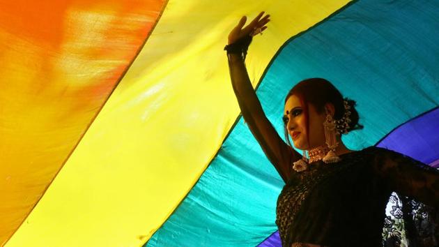 A participant walks under a rainbow flag during a pride parade promoting lesbian, gay, bisexual and transgender rights, in Chandigarh on Sunday. (Ajay Verma / REUTERS) A participant walks under a rainbow flag during a pride parade promoting lesbian, gay, bisexual and transgender rights, in Chandigarh on Sunday. (Ajay Verma / REUTERS)