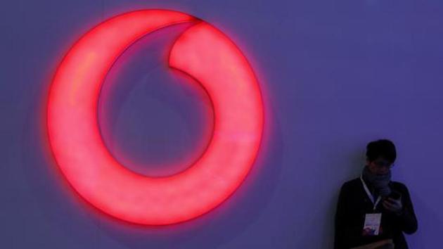 A man checks his mobile phone next to a Vodafone logo at the Mobile World Congress in Barcelona, Spain, February 28, 2018. (Reuters) A man checks his mobile phone next to a Vodafone logo at the Mobile World Congress in Barcelona, Spain, February 28, 2018. (Reuters)