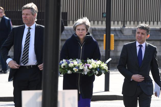 Britain's Prime Minister Theresa May lays a wreath of flowers on Parliament Square in Westminster on March 22, 2018. (Reuters) Britain's Prime Minister Theresa May lays a wreath of flowers on Parliament Square in Westminster on March 22, 2018. (Reuters)