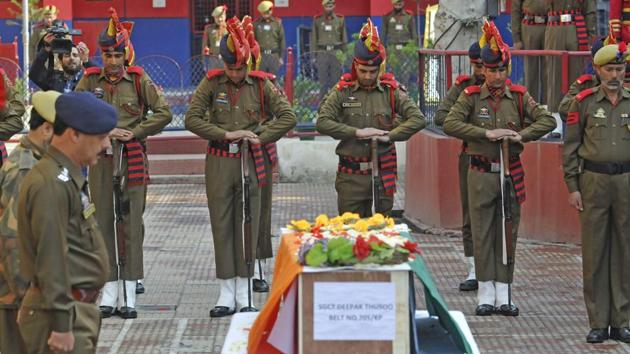Policemen pay respects during the wreath laying ceremony of their colleague Deepak Thusoo, who was killed in a gun battle with militants, at the police headquarters in Srinagar. In the bloodiest encounter in Kashmir so far this year, two policemen, three soldiers and five militants suspected to have recently crossed the Line of Control were killed in a gunbattle in a forest in Kupwara district on Wednesday. (Waseem Andrabi / HT Photo) 