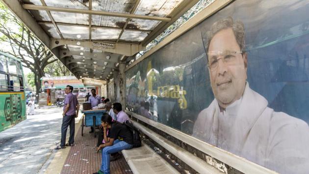 An election campaign billboard featuring an image of Karnataka Chief Minister K. Siddaramaiah, of the Indian National Congress party (INC), is displayed at a bus stop in Bengaluru, Karnataka. Siddaramaiah had tweeted, “The Karnataka BJP is so spineless that instead of asking the Centre to waive farmers’ loans it is giving accountancy lessons on Twitter.” (Prashanth Vishwanathan / Bloomberg) An election campaign billboard featuring an image of Karnataka Chief Minister K. Siddaramaiah, of the Indian National Congress party (INC), is displayed at a bus stop in Bengaluru, Karnataka. Siddaramaiah had tweeted, “The Karnataka BJP is so spineless that instead of asking the Centre to waive farmers’ loans it is giving accountancy lessons on Twitter.” (Prashanth Vishwanathan / Bloomberg)