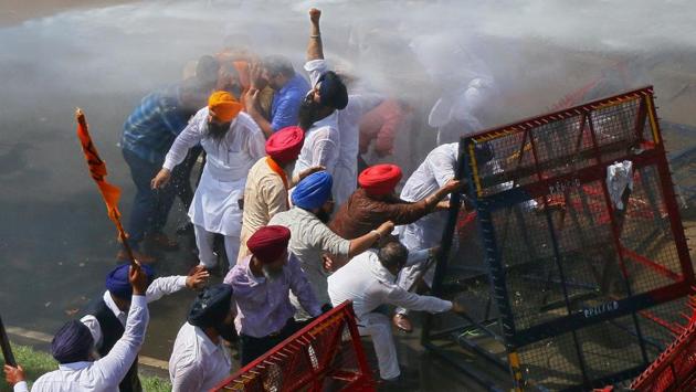 Demonstrators are hit by water cannon during a protest, organised by Punjab's main opposition party Shiromani Akali Dal (SAD), demanding debt waiver of farmers in Chandigarh on Tuesday. (Ajay Verma / REUTERS) Demonstrators are hit by water cannon during a protest, organised by Punjab's main opposition party Shiromani Akali Dal (SAD), demanding debt waiver of farmers in Chandigarh on Tuesday. (Ajay Verma / REUTERS)