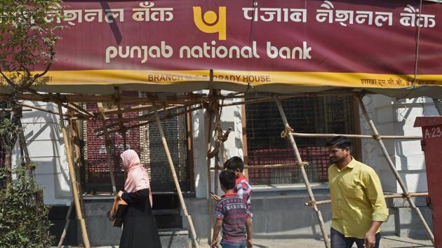 People walk past as a CBI team seals the Punjab National Bank’s South Mumbai branch at Brady House in Mumbai.(PTI File Photo)