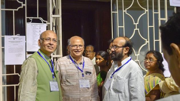 Congress nominated Rajya Sabha candidate Abhishek Singhvi (left) and Left party nominated candidate Rabin Deb (second left) share a lighter moment with different party MLA's at West Bengal Legislative Assembly during Rajya Sabha Election in Kolkata on Friday.(PTI)