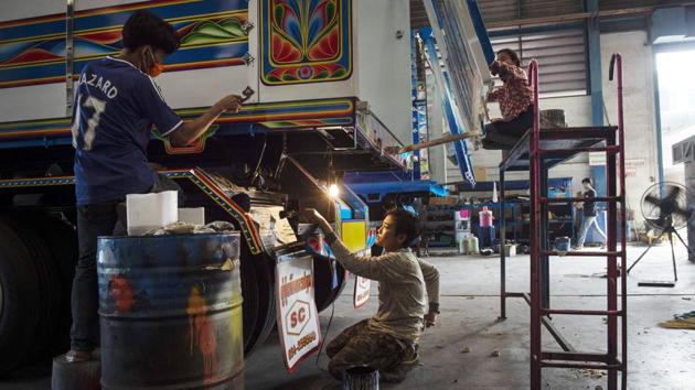 At a warehouse near Bangkok, dozens of workers cut stickers and spray on designs ranging from traditional flower patterns to Japanese robot anime craze Gundam. It belongs to Sirintra Phichitphajongkit, managing director of Soonchai Industry, one of Thailand’s largest truck assemblers that has recently devoted a section to painting trucks. “I think it’s about psychology” Sirintra told AFP. (Lillian Suwanrumpha / AFP)