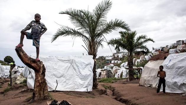 Young Congolese are seen inside a camp for Internally Displaced Persons (IDP) on March 20, 2018 in Kalemie, Democratic Republic of the Congo. An ongoing conflict between the Pygmies and Bantus has displaced 67,000 people around Kalemie and up to 650,000 at the peak of the crisis in Tanganyika Province. (John Wessels / AFP) Young Congolese are seen inside a camp for Internally Displaced Persons (IDP) on March 20, 2018 in Kalemie, Democratic Republic of the Congo. An ongoing conflict between the Pygmies and Bantus has displaced 67,000 people around Kalemie and up to 650,000 at the peak of the crisis in Tanganyika Province. (John Wessels / AFP)