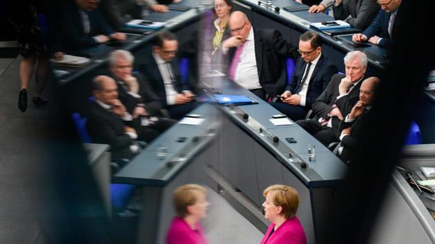 German Chancellor Angela Merkel is reflected while ministers listen to her deliver a speech to parliament on March 21, 2018 at the Bundestag in Berlin. Merkel outlined her government's plans a week after being sworn in for a fourth term following six months of political standstill. (Tobias Schwarz / AFP) German Chancellor Angela Merkel is reflected while ministers listen to her deliver a speech to parliament on March 21, 2018 at the Bundestag in Berlin. Merkel outlined her government's plans a week after being sworn in for a fourth term following six months of political standstill. (Tobias Schwarz / AFP)