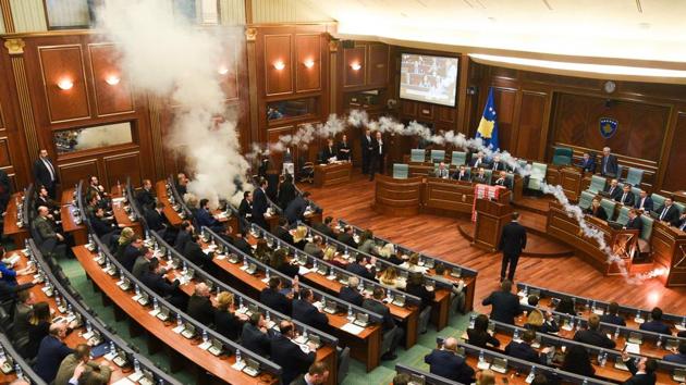Kosovo's opposition lawmakers release a teargas canister inside the country's parliament in Pristina on March 21, 2018 before a vote for an agreement to ratify or not a border demarcation deal signed in 2015 with Montenegro. (Armend Nimani / AFP) Kosovo's opposition lawmakers release a teargas canister inside the country's parliament in Pristina on March 21, 2018 before a vote for an agreement to ratify or not a border demarcation deal signed in 2015 with Montenegro. (Armend Nimani / AFP)
