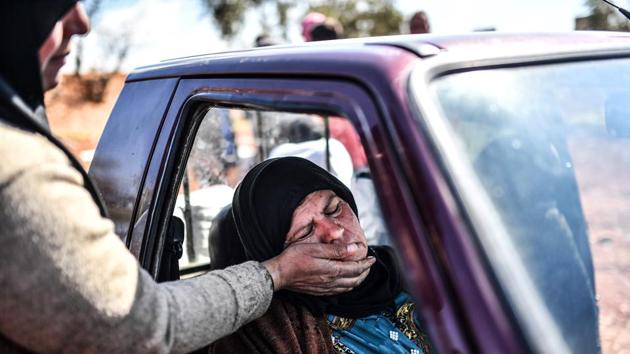 A woman sits in a car as people arrive at a check point in the village of Anab ahead of crossing to the Turkish-backed Syrian rebels side on March 17, 2018, as civilians flee the city of Afrin in northern Syria. (Bulent Kilic / AFP) A woman sits in a car as people arrive at a check point in the village of Anab ahead of crossing to the Turkish-backed Syrian rebels side on March 17, 2018, as civilians flee the city of Afrin in northern Syria. (Bulent Kilic / AFP)