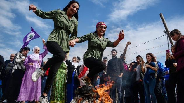 Women jump over a bonfire during a Kurdish celebration of Nowruz (also Noruz or Newroz), the Persian calendar New Year in Istanbul, Turkey on March 21, 2018. (Ozan Kose / AFP) Women jump over a bonfire during a Kurdish celebration of Nowruz (also Noruz or Newroz), the Persian calendar New Year in Istanbul, Turkey on March 21, 2018. (Ozan Kose / AFP)