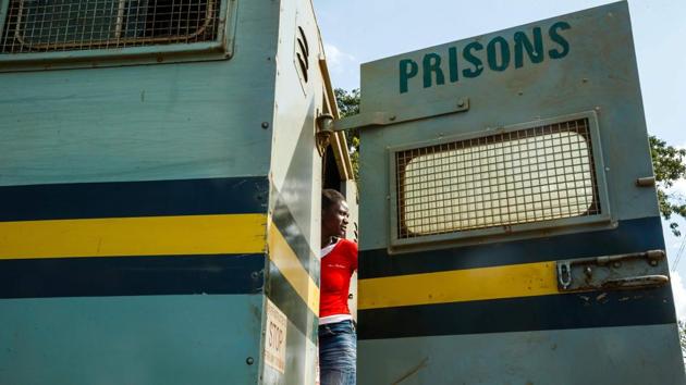 One of the inmates who were released on March 22, 2018, takes one last look at the prison as she stands in the back of a prison’s truck. Prisoners convicted of murder, treason, rape, carjacking, armed robbery and those serving a sentence imposed by a court martial were excluded from the amnesty. (Jekesai Njikizana / AFP)