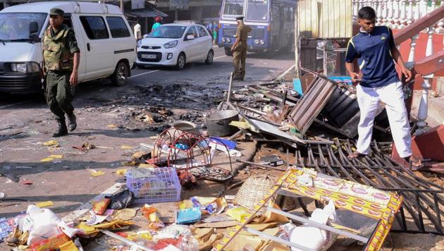 Police commandos patrol next to debris from a damaged shop in the central district of Kandy in Sri Lanka on March 6. (AFP File Photo) Police commandos patrol next to debris from a damaged shop in the central district of Kandy in Sri Lanka on March 6. (AFP File Photo)