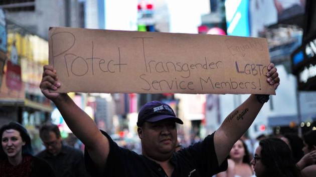 A protester displays a placard during a demonstration against US President Donald Trump, in front of the US Army career centre in Times Square, New York. (AFP File Photo) A protester displays a placard during a demonstration against US President Donald Trump, in front of the US Army career centre in Times Square, New York. (AFP File Photo)