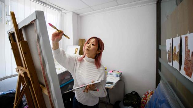 Mural artist Jackie Chung, 36, who works under the name "Pinkhead". (AFP) Mural artist Jackie Chung, 36, who works under the name "Pinkhead". (AFP)