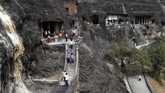 Nearly 4,000 people visit the caves daily. To minimize this impact on the fragile murals and statues, the Archaeological Survey of India (ASI) has prohibited camera flash or harsh lights, limited viewing time to 10 minutes and placed barriers to prevent viewers from touching the artwork that’s missing portions, due to antiquity, water seepage, vandalism and robbery.  (Ajay Aggarwal / HT Photo) 