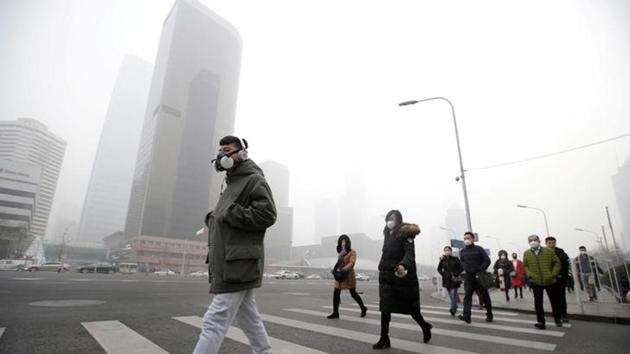 A man wearing a respiratory protection mask walks toward an office building during smog in Beijing's central business district, China. (Reuters file photo)