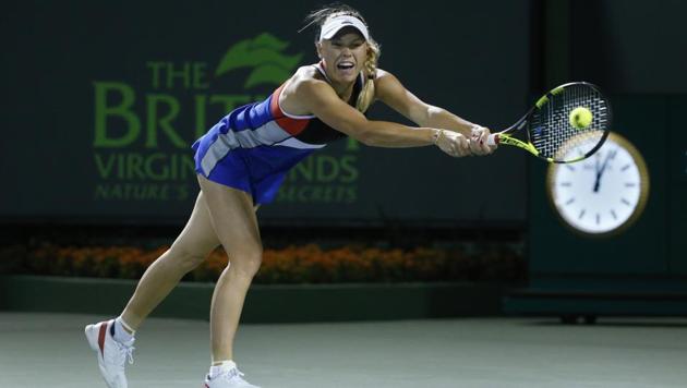 Caroline Wozniacki, of Denmark, returns a shot from Monica Puig, of Puerto Rico, at the Miami Open tennis tournament early Saturday in Key Biscayne. (AP) Caroline Wozniacki, of Denmark, returns a shot from Monica Puig, of Puerto Rico, at the Miami Open tennis tournament early Saturday in Key Biscayne. (AP)