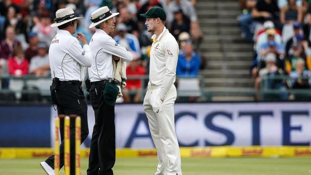 Australian fielder Cameron Bancroft (R) is questioned by umpires Richard Illingworth (L) and Nigel Llong (C) during the third day of the third Test vs South Africa at Newlands on Saturday. (AFP) Australian fielder Cameron Bancroft (R) is questioned by umpires Richard Illingworth (L) and Nigel Llong (C) during the third day of the third Test vs South Africa at Newlands on Saturday. (AFP)