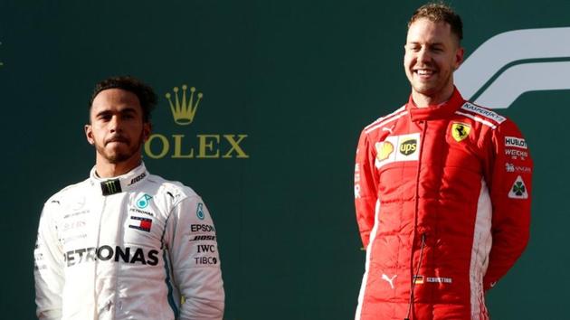 Ferrari's Sebastian Vettel (R) celebrates his Australian Grand Prix win on the podium with Mercedes' Lewis Hamilton. (REUTERS)
