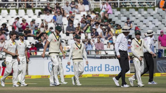 Steven Smith of Australia, center, takes to the field with the team on the fourth day of the third cricket test between South Africa and Australia at Newlands Stadium, in Cape Town, South Africa, Sunday.(AP)