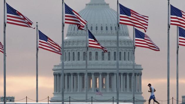 An early morning runner crosses in front of the US Capitol as he passes the flags circling the Washington Monument in Washington. (AP File Photo) An early morning runner crosses in front of the US Capitol as he passes the flags circling the Washington Monument in Washington. (AP File Photo)