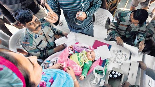 Army doctor check a 10-month-old at a medical camp in Hyderpora.(HT File Photo)