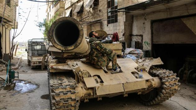 A Syrian government soldier sits on a tank stationed on the edges of the town of Zamalka in Eastern Ghouta. The evacuations are expected to pave the way for an announcement by Damascus establishing government control. Even before the onslaught, the enclave’s 400,000 residents had suffered a crippling regime siege that severely limited access to food and medicine since 2013. (AFP) A Syrian government soldier sits on a tank stationed on the edges of the town of Zamalka in Eastern Ghouta. The evacuations are expected to pave the way for an announcement by Damascus establishing government control. Even before the onslaught, the enclave’s 400,000 residents had suffered a crippling regime siege that severely limited access to food and medicine since 2013. (AFP)
