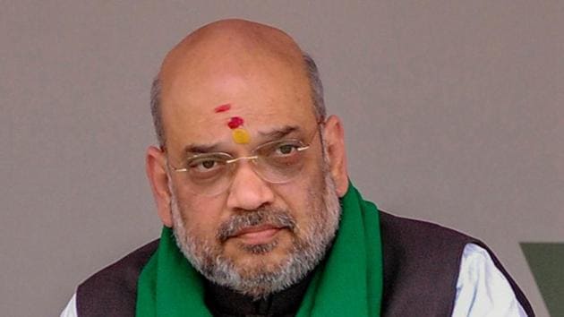 BJP president Amit Shah looks on during a statewide door-to-door campaign in Davanagere on Tuesday. (PTI Photo) BJP president Amit Shah looks on during a statewide door-to-door campaign in Davanagere on Tuesday. (PTI Photo)