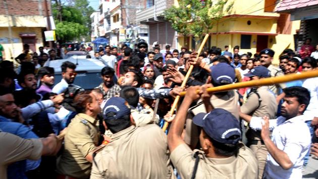 Police control the members of two communities, who clashed in Dehradun on Monday. (Vinay S Kumar/HT) Police control the members of two communities, who clashed in Dehradun on Monday. (Vinay S Kumar/HT)