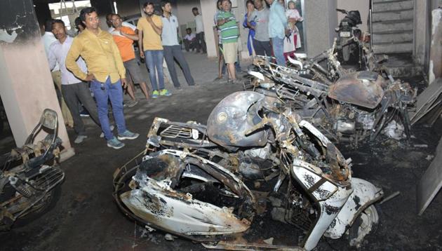 Ten bikes and a car were gutted at a residential building in Vijay Nagar early Tuesday. (Sakib Ali /HT Photo) Ten bikes and a car were gutted at a residential building in Vijay Nagar early Tuesday. (Sakib Ali /HT Photo)