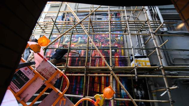 Trained in watercolour and acrylic painting, British artist Dan Kitchener is particularly fond of portraying neon lights, reflections and rain sights that first captivated him in Tokyo. “Hong Kong’s got that feel to me -- the epic scale and the skyscrapers, and then it’s got these little tiny alleyways,” Kitchener said as he painted on the wall of a city bar. (Anthony Wallace / AFP) 
