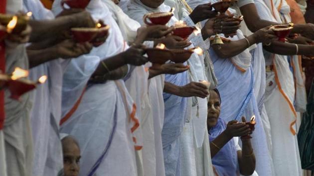 Widows hold lit diyas during Diwali celebrations at Kesi Ghat on the banks of the Yamuna river in Vrindavan. (AFP FILE PHOTO) Widows hold lit diyas during Diwali celebrations at Kesi Ghat on the banks of the Yamuna river in Vrindavan. (AFP FILE PHOTO)