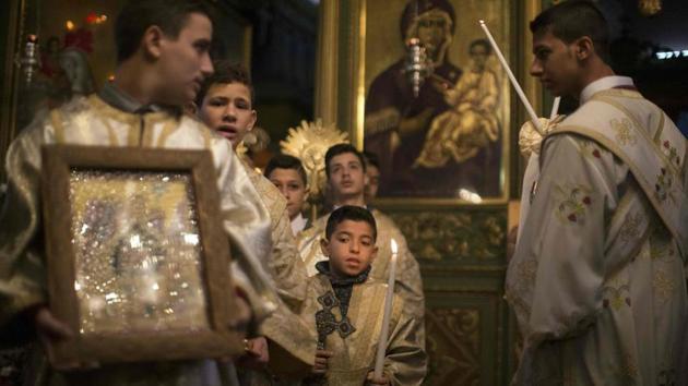 Palestinian Orthodox Christian altar boys attend a Christmas mass at the Saint Porphyrios Greek Orthodox church in Gaza City on January 7, 2017. (AFP File Photo) Palestinian Orthodox Christian altar boys attend a Christmas mass at the Saint Porphyrios Greek Orthodox church in Gaza City on January 7, 2017. (AFP File Photo)