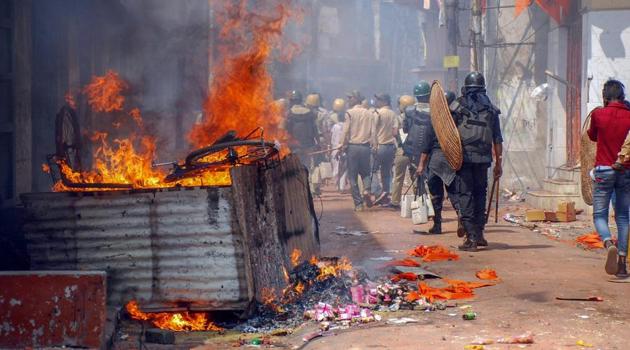 Police personnel patrol after a clashes and incidents of arson took place over a Ram Navami procession at Raniganj in Burdwan district on March 26.(PTI Photo)