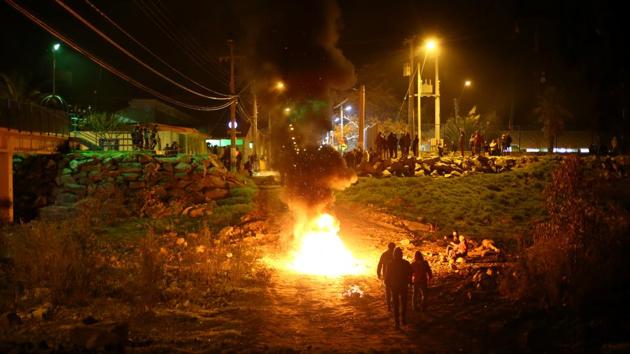 Residents make barricades as they gather to protest against a new industrial waste processing facility that is being constructed in Til Til, Chile. This town of 17,000 is the last stop for much of the trash produced by the capital Santiago, a city of 7 million. And now there will be more. (Ivan Alvarado / REUTERS) Residents make barricades as they gather to protest against a new industrial waste processing facility that is being constructed in Til Til, Chile. This town of 17,000 is the last stop for much of the trash produced by the capital Santiago, a city of 7 million. And now there will be more. (Ivan Alvarado / REUTERS)