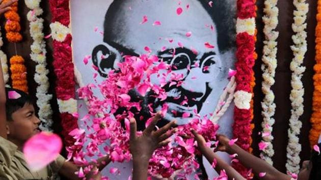 School children pay homage to a portrait of Mahatma Gandhi on his 70th death anniversary in Chennai on January 30, 2018. (PTI) School children pay homage to a portrait of Mahatma Gandhi on his 70th death anniversary in Chennai on January 30, 2018. (PTI)