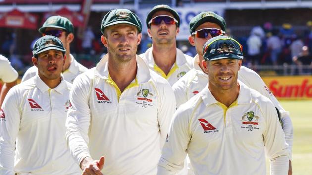 Australia's David Warner, right, leads his team off the field after losing the second cricket Test versus South Africa at St. George's Park in Port Elizabeth, March 12, 2018. Warner has been sent home by Cricket Australia in the wake of the ball-tampering scandal. LG has dropped him as a brand ambassador.(AP)