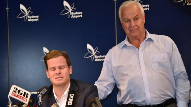 Steve Smith (L) is comforted by his father Peter as he reacts at a press conference at the Sydney Airport. (AFP)