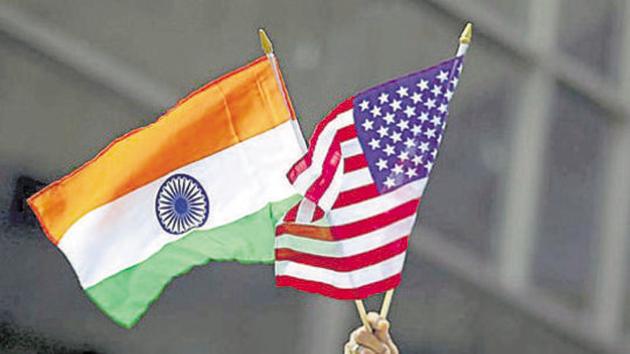 A man holds the flags of India and the US while people take part in the 35th India Day Parade in New York on August 16, 2015.(REUTERS FILE)