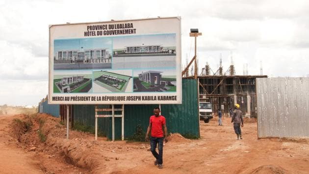 Even the headquarters for the local government are being financed by revenues from cobalt mining. While no deaths have been reported in the partnership mine so far, a sign of some progress, the prospect of small fortunes underneath gardens and backyards remains. Intensive digging has started just outside mine walls in some areas and government is rushing to open legal sites quickly. (William Clowes / Bloomberg)