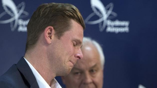 Former Australian cricket captain Steve Smith, left, grimaces as he walks past his father, Peter, after speaking to the media in Sydney on Thursday. (AP) Former Australian cricket captain Steve Smith, left, grimaces as he walks past his father, Peter, after speaking to the media in Sydney on Thursday. (AP)