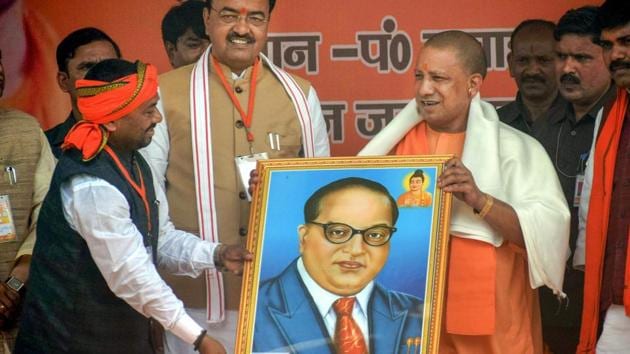 UP Chief Minister Yogi Aditya Nath being presented a portrait of Dr BR Ambedkar during an election rally Allahabad on March 3, 2018.(PTI File Photo)