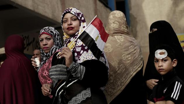 Women wait in line to vote outside a polling station at a school in the Omraniyah district of Giza, Egypt. Turnout appeared low as Egyptians voted in an election that President Abdel-Fattah el-Sissi is virtually certain to win, after all serious rivals were either arrested or intimidated into dropping out. (Nariman El-Mofty / AP)